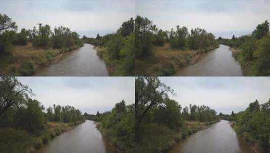 大雨中棕色河水的小河航拍高清在线视频素材下载