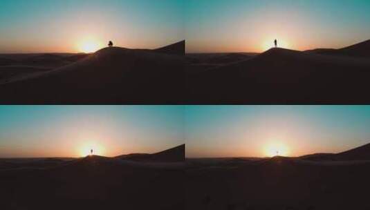 精品 · 航拍沙漠夕阳下的人物剪影高清在线视频素材下载