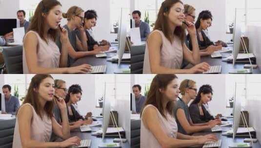 三位戴着耳机的女性在办公室的电脑前工作高清在线视频素材下载