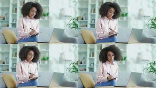 年轻的非裔美国女学生使用笔记本电脑收听在高清在线视频素材下载