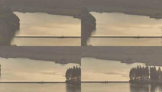 长焦下的公园湖面日落夕阳美景航拍高清在线视频素材下载