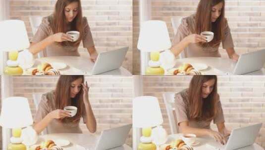迷人的女孩坐在咖啡馆里玩电脑喝咖啡高清在线视频素材下载