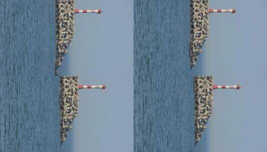 威海远遥渔港驶过灯塔的小渔船高清在线视频素材下载