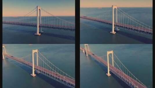大连航拍海边跨海湾大桥唯美岩壁大海夕阳高清在线视频素材下载