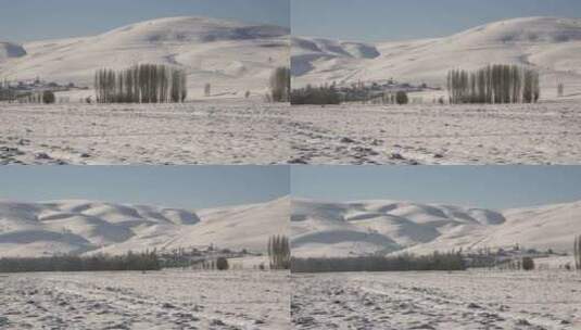 俄罗斯冬季西伯利亚大雪平原和山坡边缘的村庄房屋高清在线视频素材下载