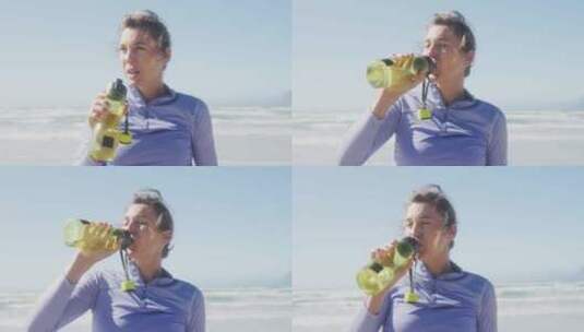 在海滩上喝水的运动妇女高清在线视频素材下载
