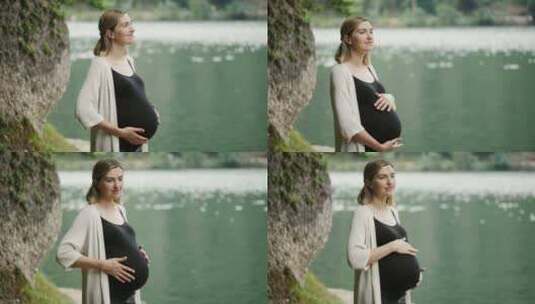 孕妇站在山湖附近轻轻抚摸肚子高清在线视频素材下载
