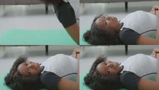 美丽的黑人非裔美国女孩躺在地上训练后深呼高清在线视频素材下载