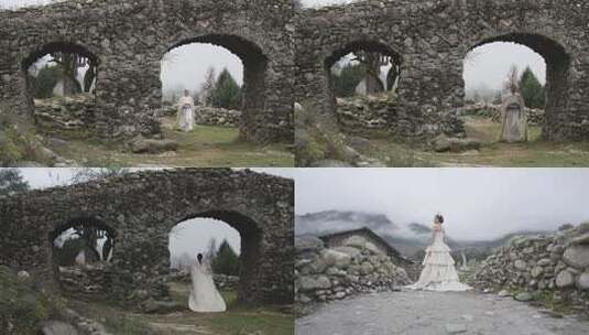 少数民族女子于石拱古迹处站立高清在线视频素材下载