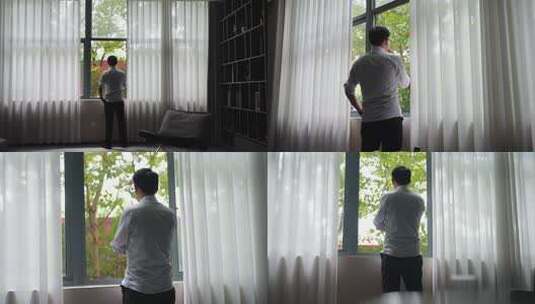 男子窗边思考背影高清在线视频素材下载