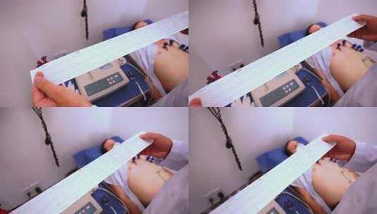 医生医院内查看病人心电图高清在线视频素材下载