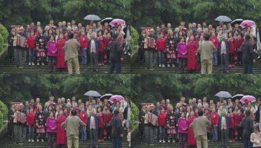 雨中合唱爱国歌曲的退休老年人高清在线视频素材下载