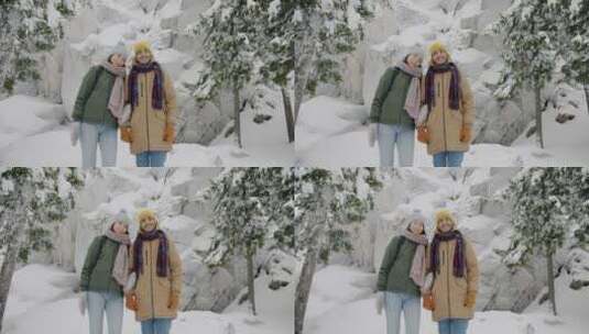 情侣站在冬季的森林里高清在线视频素材下载