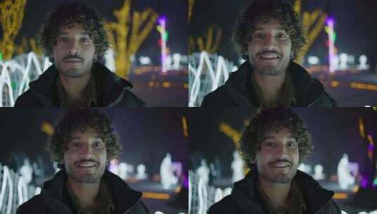 冬夜，年轻的印度男子站在户外，背景是花环高清在线视频素材下载