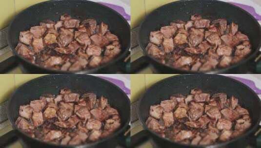在家庭厨房的煎锅里煎猪肉块高清在线视频素材下载