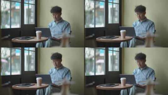 年轻人在咖啡厅使用笔记本电脑办公高清在线视频素材下载