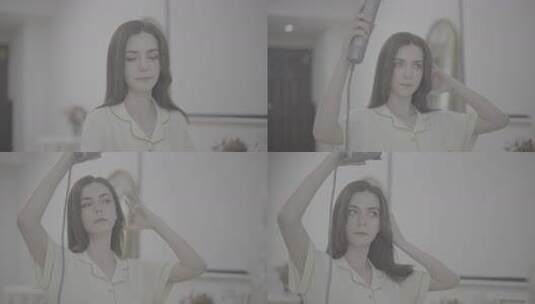 女性居家手持吹风机吹发高清在线视频素材下载