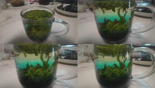 透明杯中泡开的绿茶高清在线视频素材下载