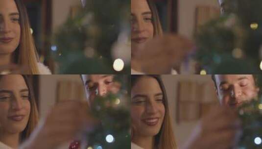 对年轻夫妇一起装饰圣诞树的特写镜头高清在线视频素材下载