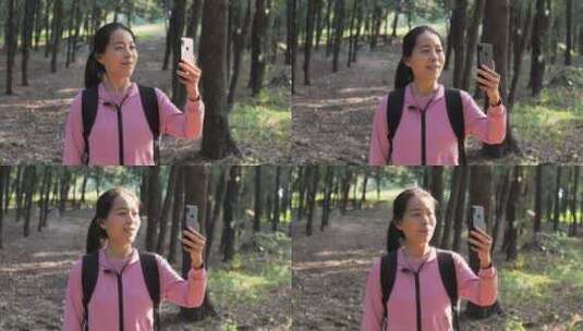亚洲中国人女人树林旅游漫步拍照对话看风景高清在线视频素材下载