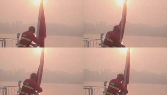 太阳升起时船员梳理国旗高清在线视频素材下载
