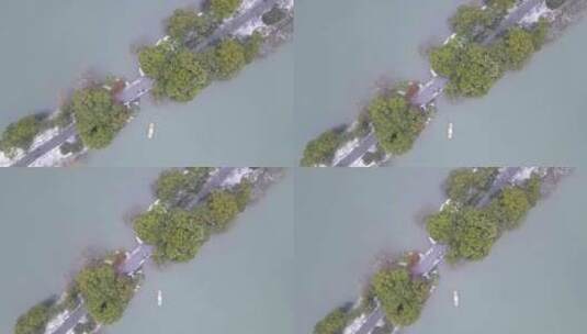 航拍雪中杭州西湖-船过望山桥高清在线视频素材下载