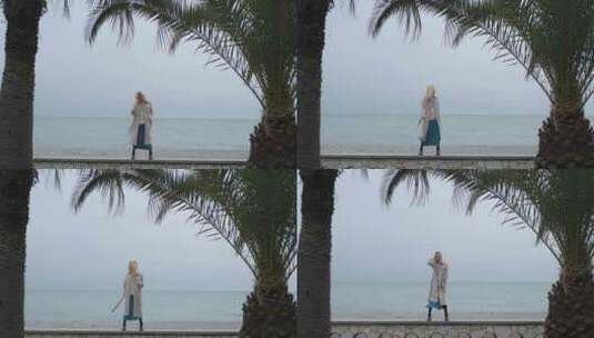 女人在棕榈树间的海滩上跳舞高清在线视频素材下载