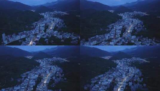 航拍广东茂名信宜钱排镇群山环绕的城镇夜景高清在线视频素材下载