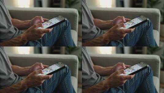 男子沙发上操作智能手机高清在线视频素材下载