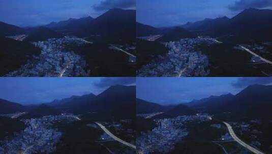 航拍广东茂名信宜钱排镇群山环绕的城镇夜景高清在线视频素材下载