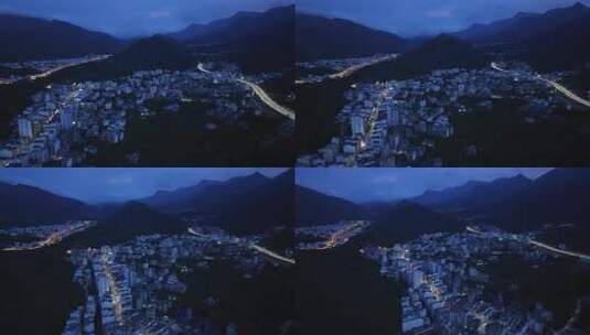 航拍广东茂名信宜钱排镇群山环绕的城镇夜景高清在线视频素材下载