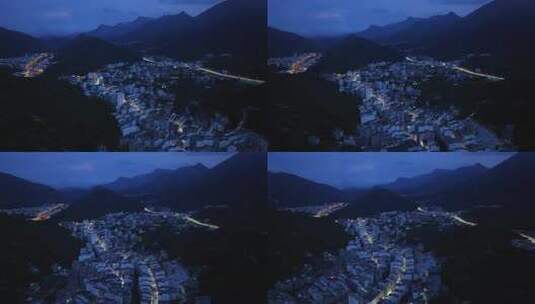 航拍广东茂名信宜钱排镇群山环绕的城镇夜景高清在线视频素材下载
