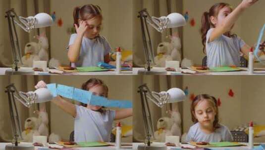 学龄前女孩用剪刀从彩色纸上剪下工艺品高清在线视频素材下载