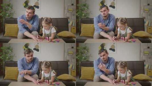 放纵的爸爸用女儿的指甲油和头发松紧带进行高清在线视频素材下载