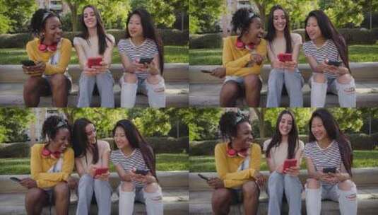 三个快乐的多种族女性在夏季使用电话坐在户高清在线视频素材下载