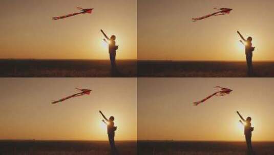 女人在夕阳下放风筝的剪影高清在线视频素材下载
