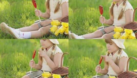 女孩坐在草地上吃棒棒糖高清在线视频素材下载