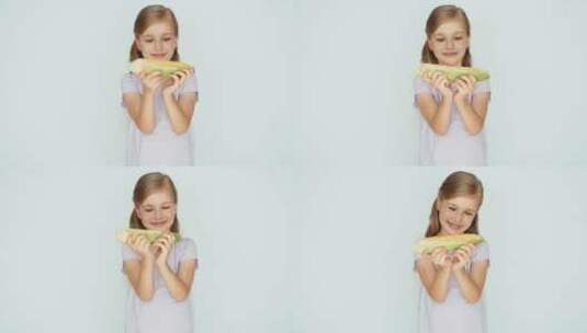 小女孩捧着闻玉米高清在线视频素材下载