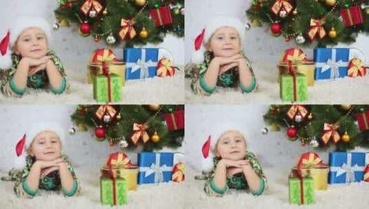 小女孩开心的趴在圣诞树旁边高清在线视频素材下载