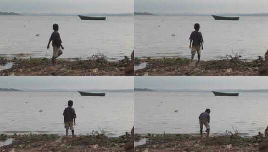 小男孩在乌干达维多利亚湖岸边玩耍高清在线视频素材下载