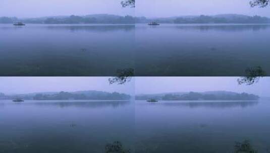 一艘渔船划在黄昏时烟雾迷蒙的杭州西湖上高清在线视频素材下载