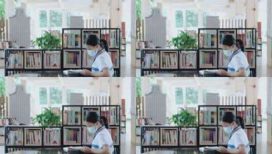 初中校园图书馆女生戴着口罩看书学习4k视频高清在线视频素材下载