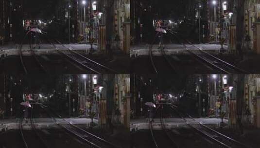 大伞穿过铁路的女人高清在线视频素材下载