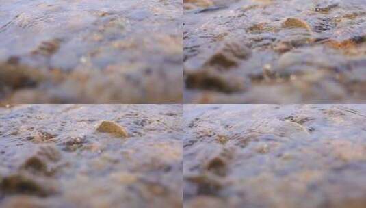清澈的河水冲刷岸边的石头高清在线视频素材下载