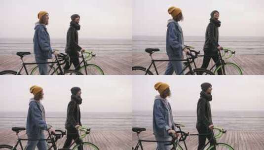 情侣推着自行车在海边散步高清在线视频素材下载