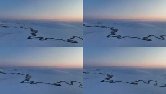 航拍雪原上蜿蜒的冰封河流暮色高清在线视频素材下载