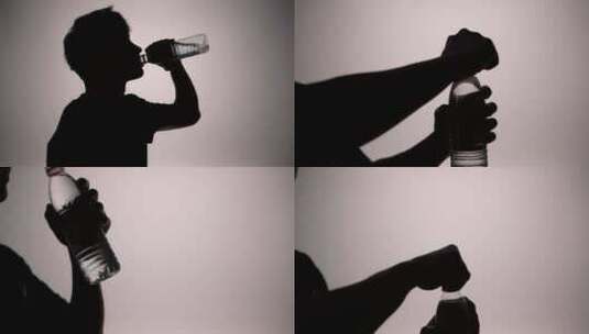 男人喝水剪影男人拧开矿泉水瓶喝水运动喝水高清在线视频素材下载
