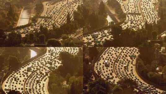 在建筑物和树木附近的繁忙高速公路上行驶的高清在线视频素材下载