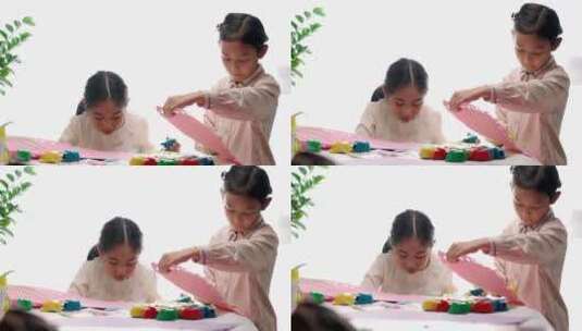 两名认真玩剪纸游戏的中国女孩升格高清在线视频素材下载