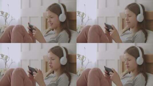女孩在卧室听音乐玩手机高清在线视频素材下载
